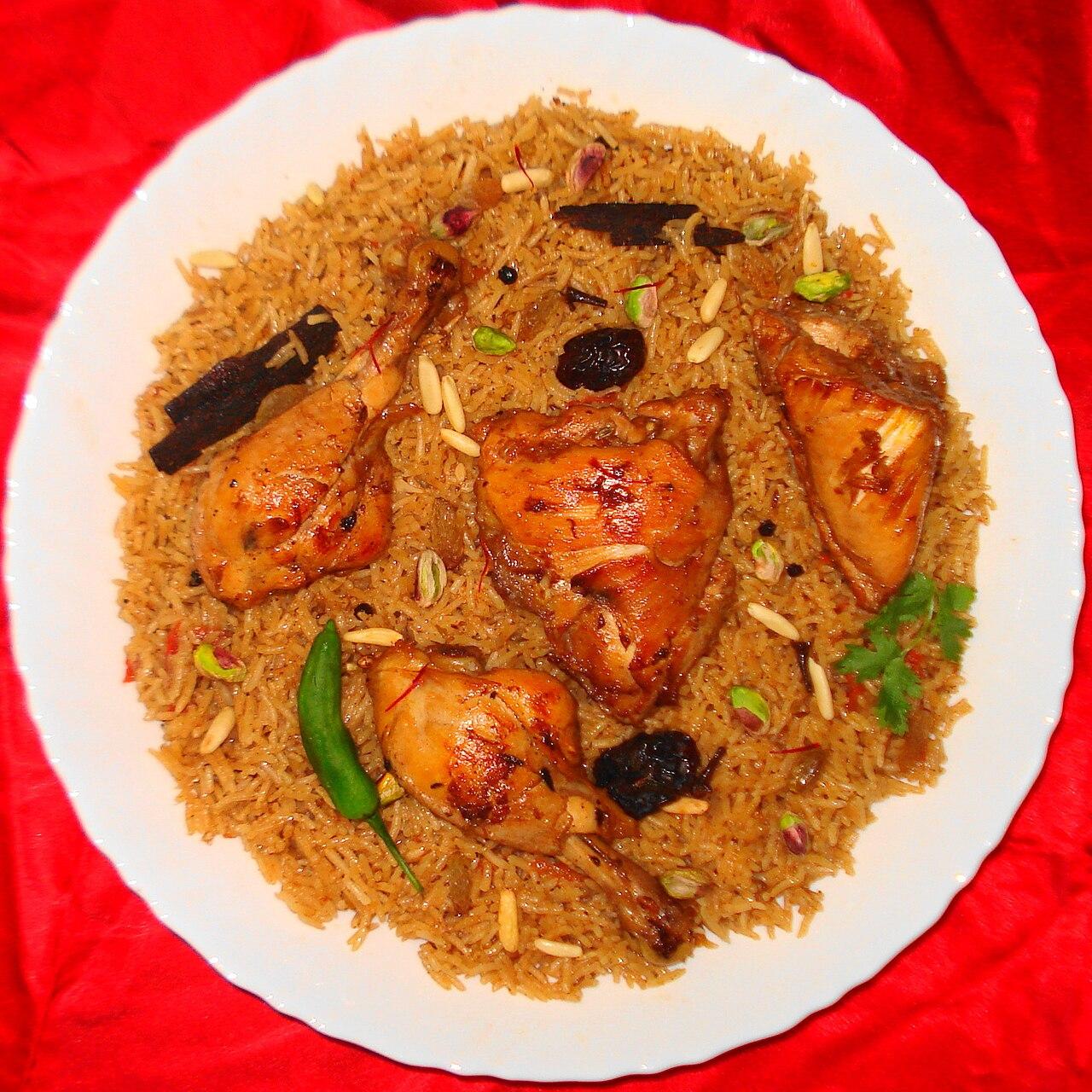 An overhead shot of chicken machboos — spiced Gulf rice with chicken, nuts and dried fruit — Bahrain's favorite dish