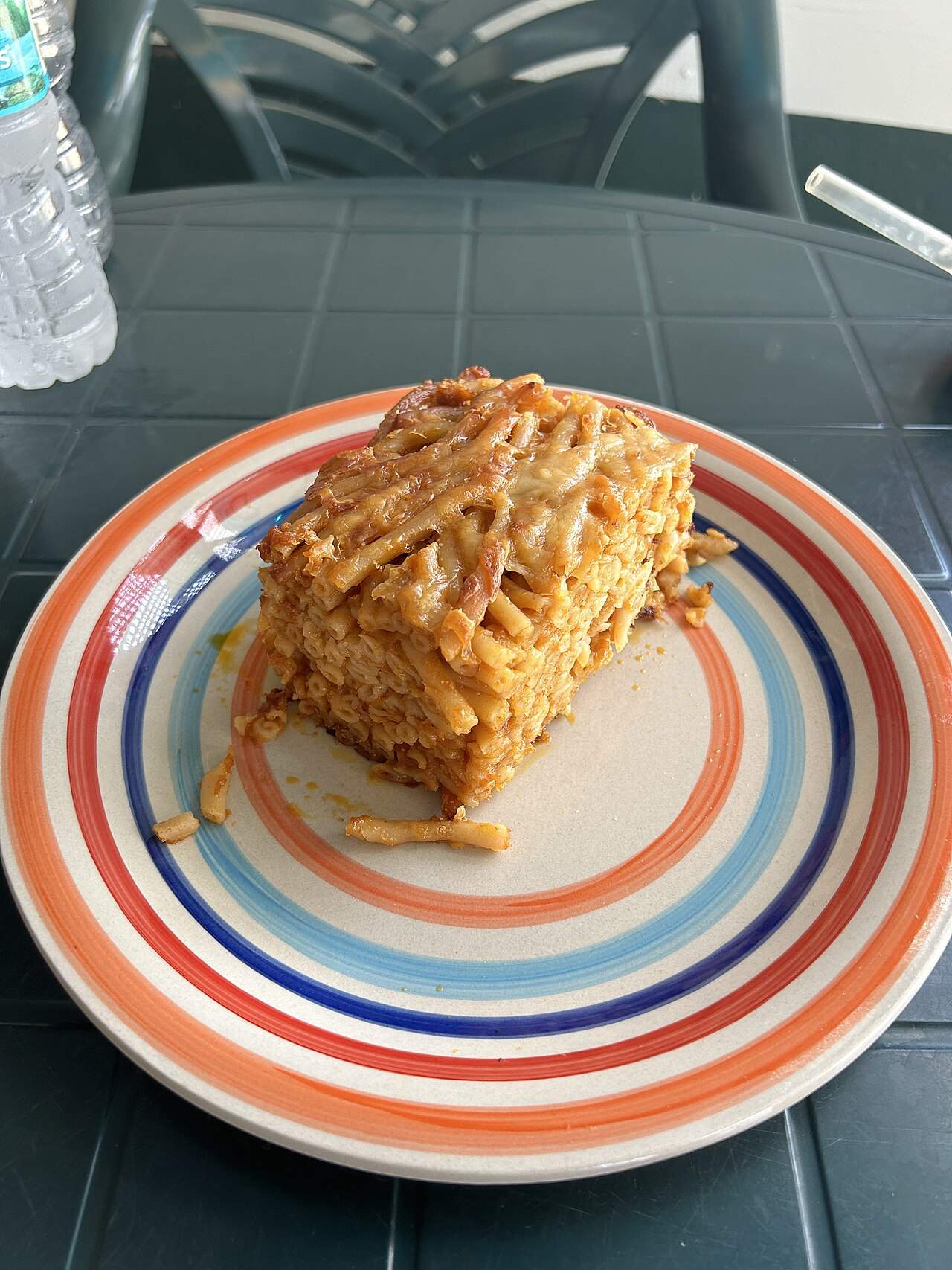 A slice of Bajan macaroni pie — the beloved Barbadian baked-pasta comfort dish — from Delon's Roti & Bar in St. Philip, Barbados
