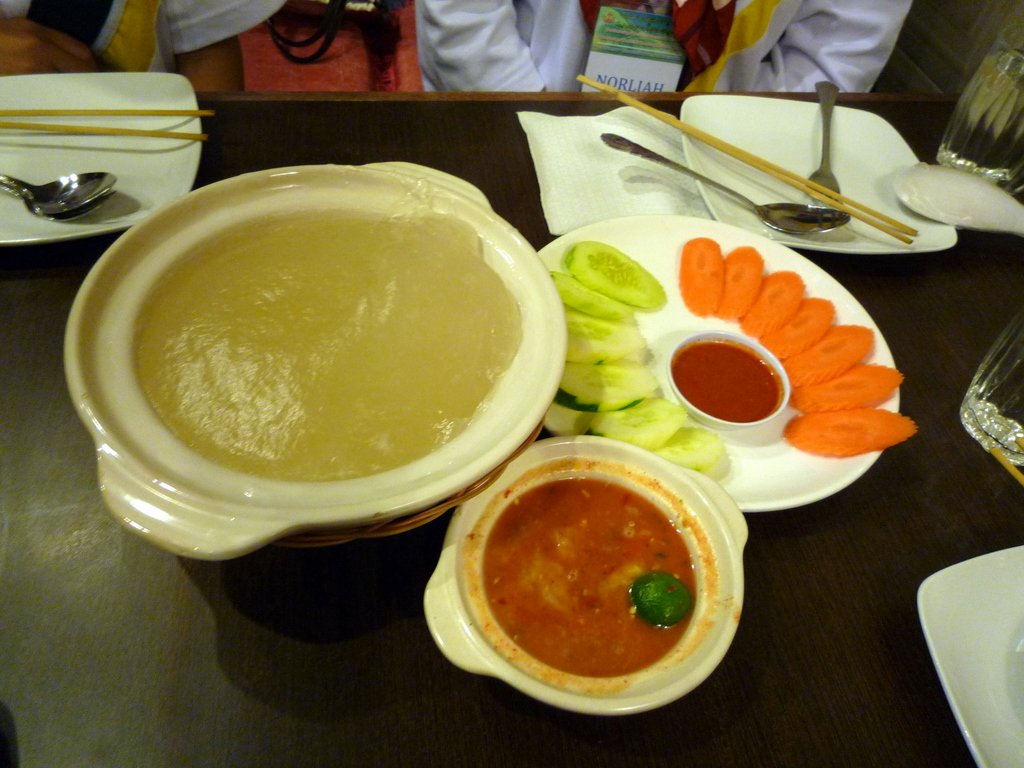 A bowl of ambuyat, Brunei's national dish of sago starch, with dipping sauce, cucumber and carrot