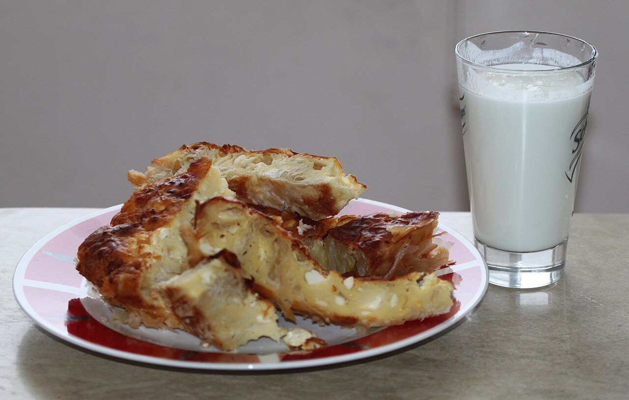 Slices of banitsa, Bulgaria's cheese-filled pastry, served with a glass of yogurt