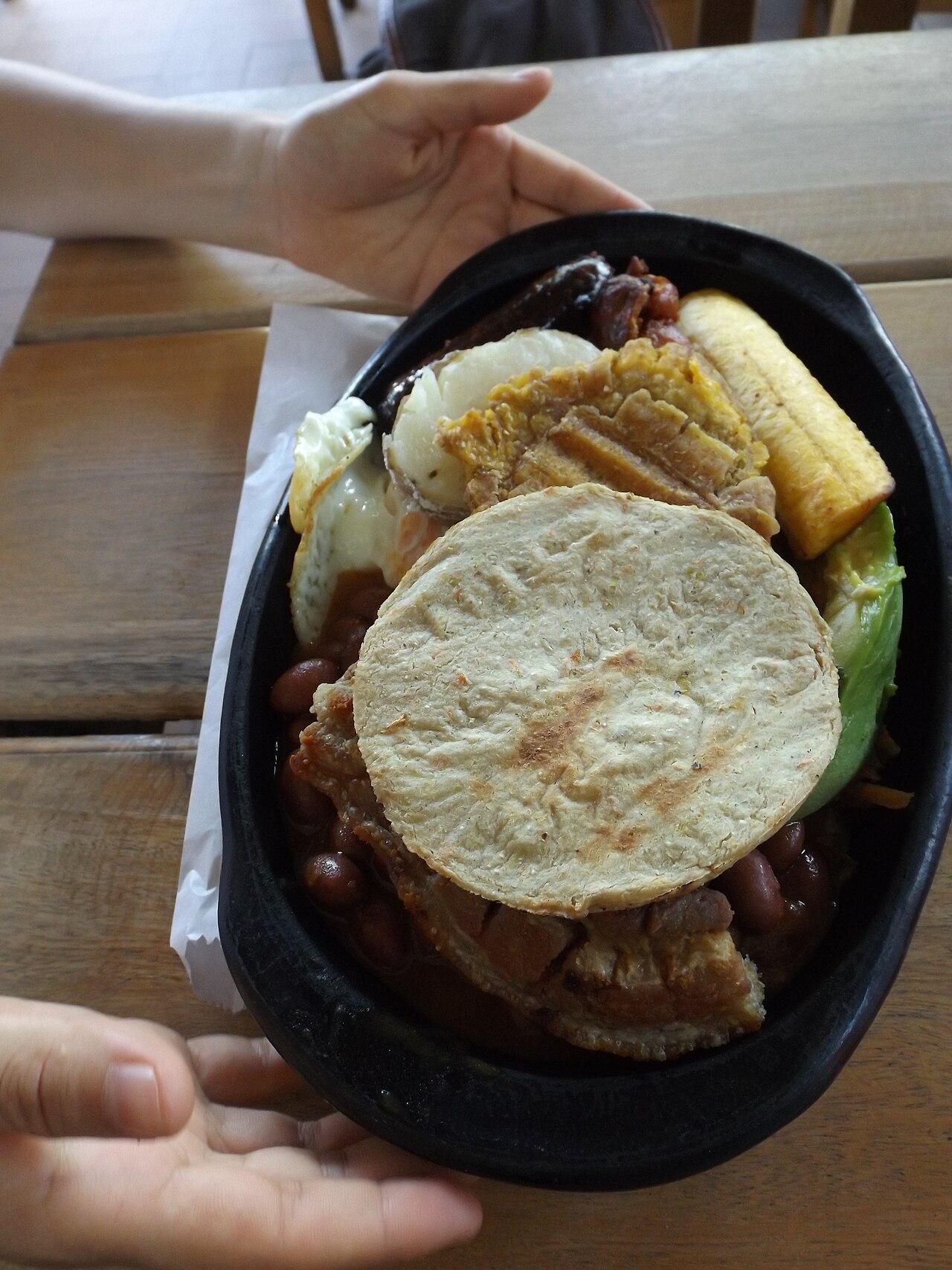 A bandeja paisa — Colombia's hearty platter of beans, rice, plantain, egg, and meats — served in Guatapé