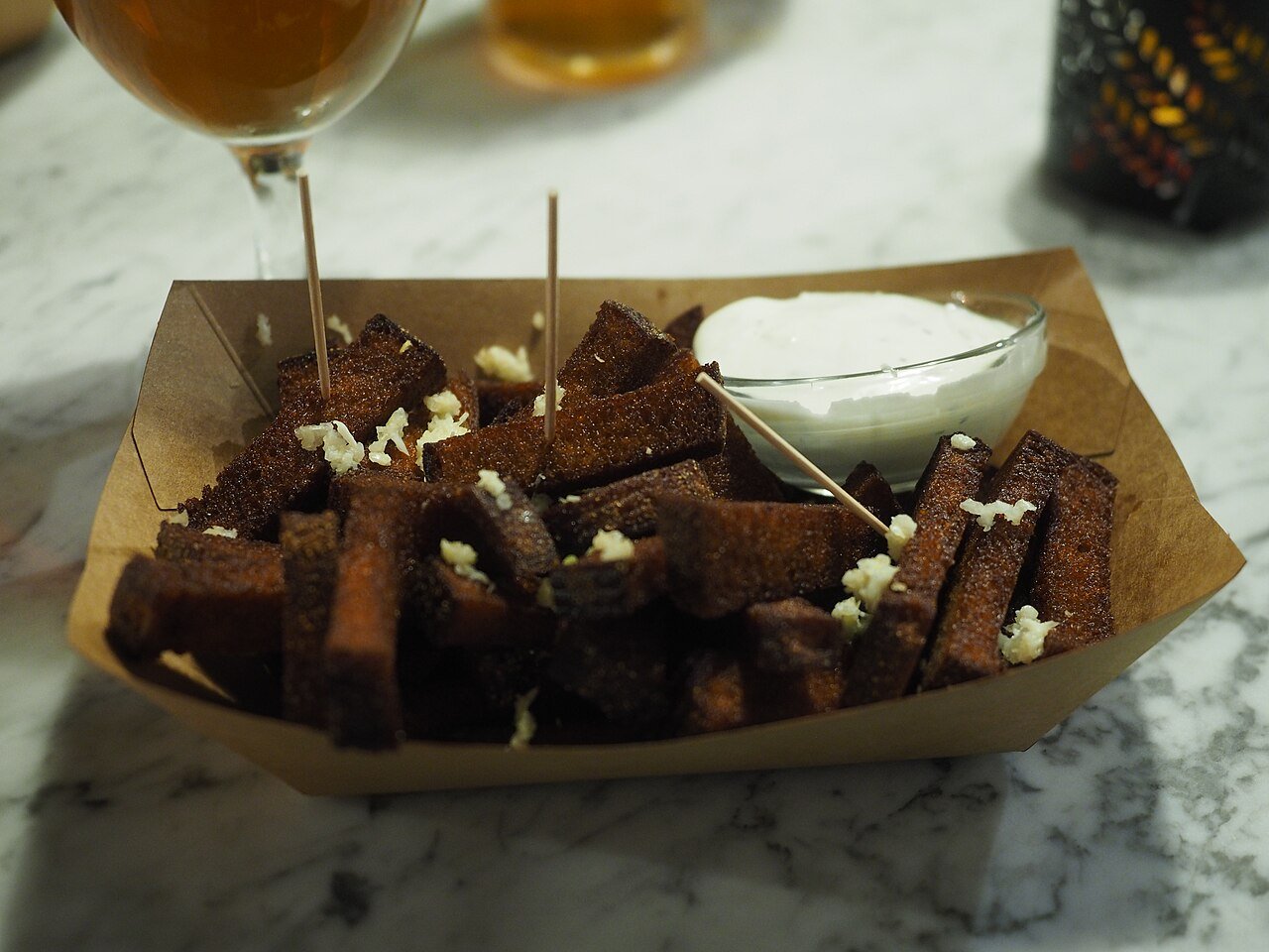 A tray of fried garlic rye bread sticks with garlic mayo, the classic Estonian bar snack, in Tallinn