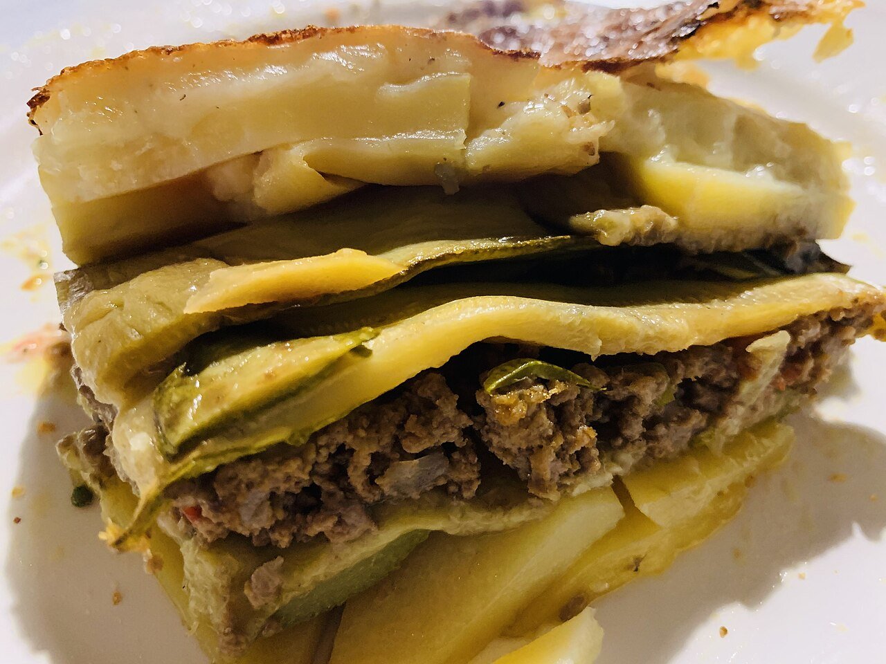 A slice of moussaka layered with minced lamb, vegetables, and béchamel in Crete, Greece
