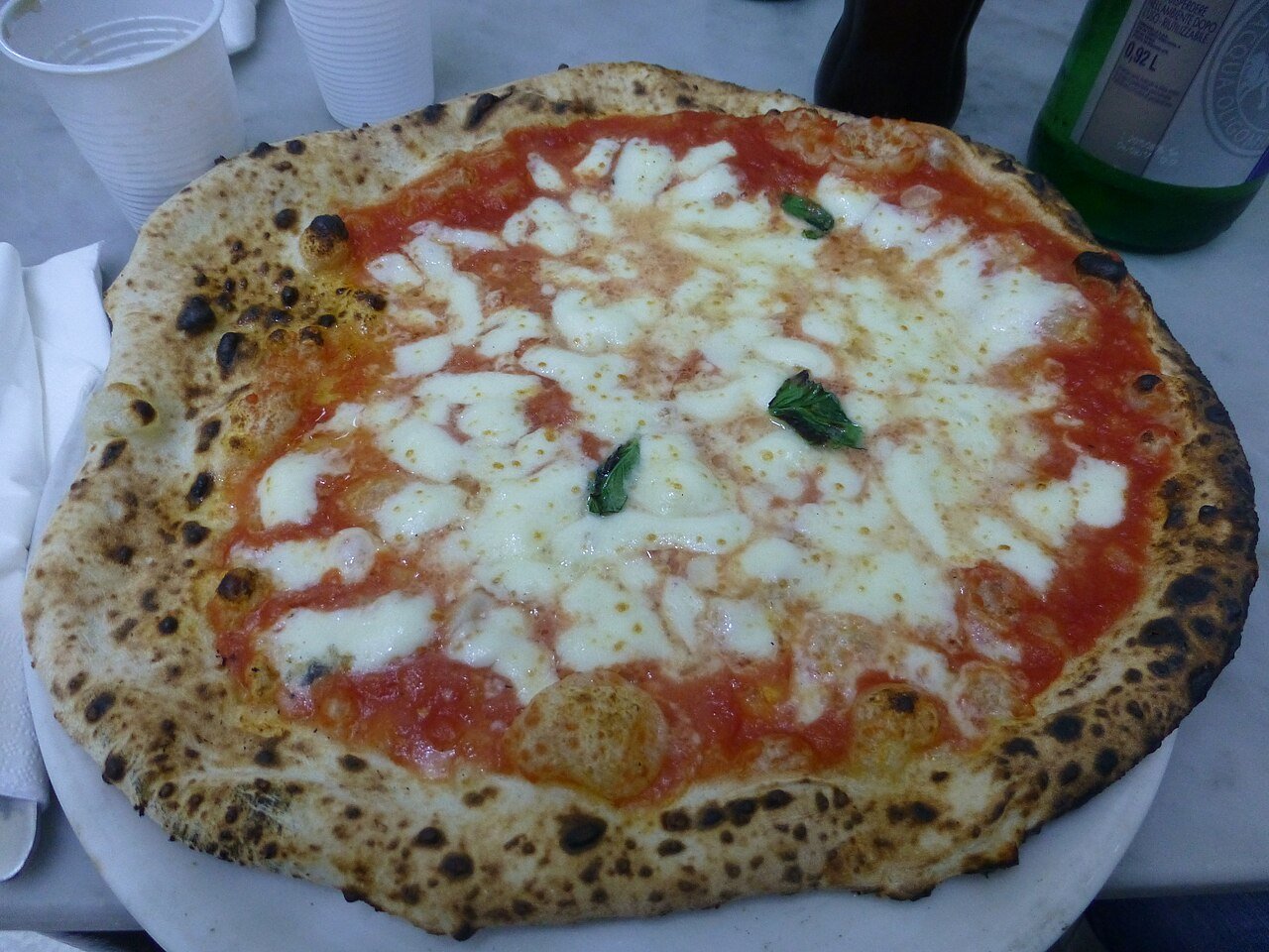 A Neapolitan pizza margherita with tomato, mozzarella and basil