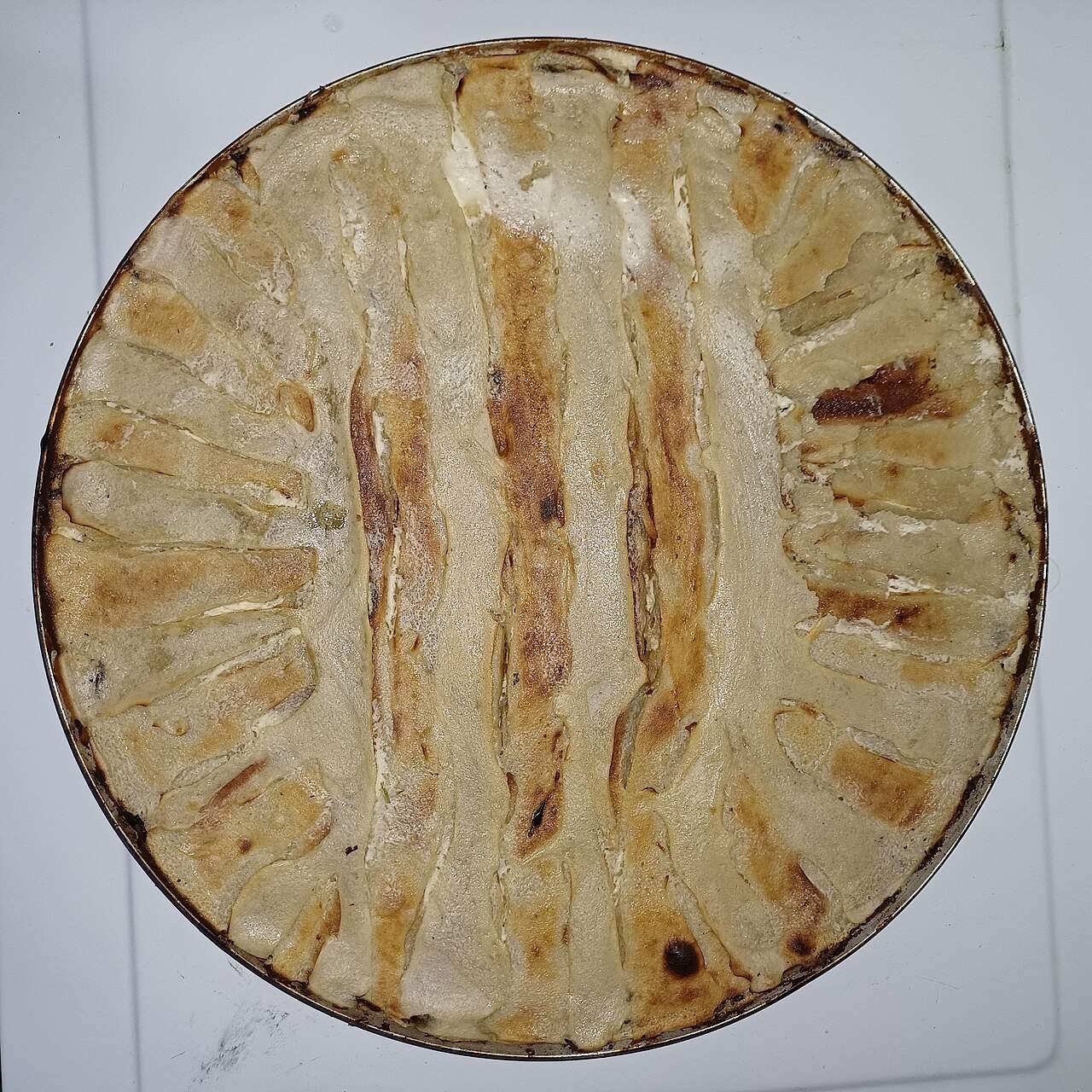 Flija, Kosovo's traditional layered batter dish, baked in a round pan