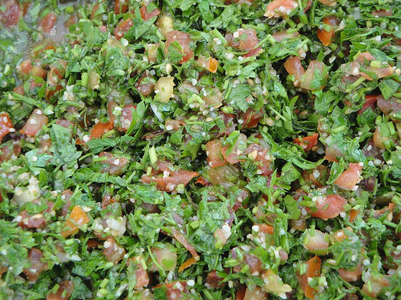 A vibrant bowl of fresh tabbouleh, the classic Lebanese parsley and tomato salad, made in Beirut