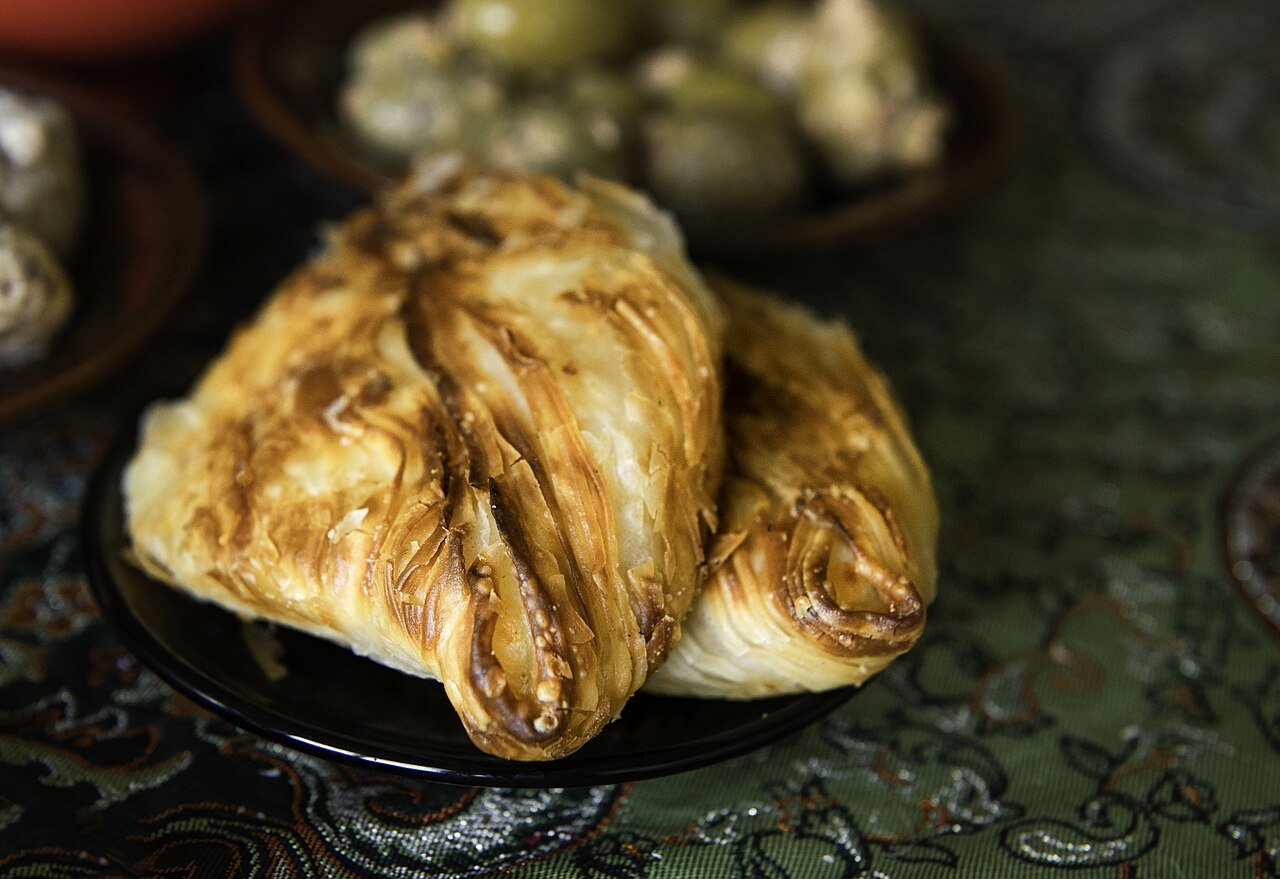 Freshly baked pastizzi — Malta's flaky filled pastries — on a plate