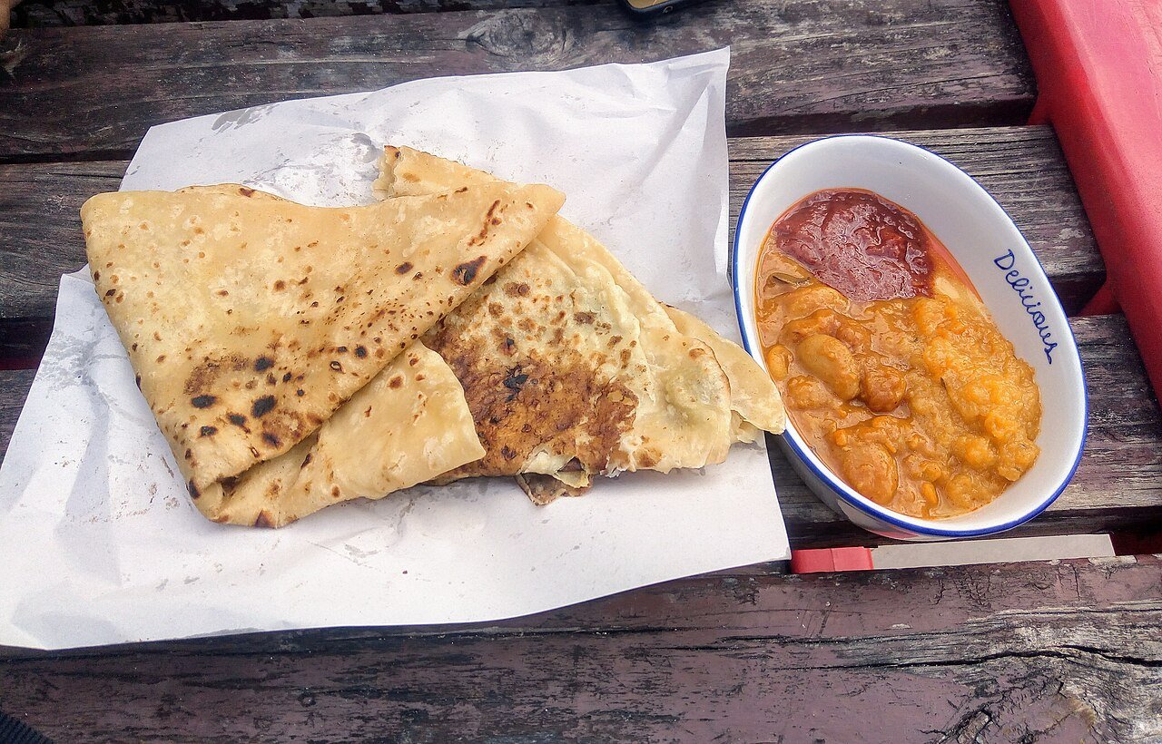 Dholl puri — split-pea flatbread served with curries — Mauritius's beloved street food on a wooden table