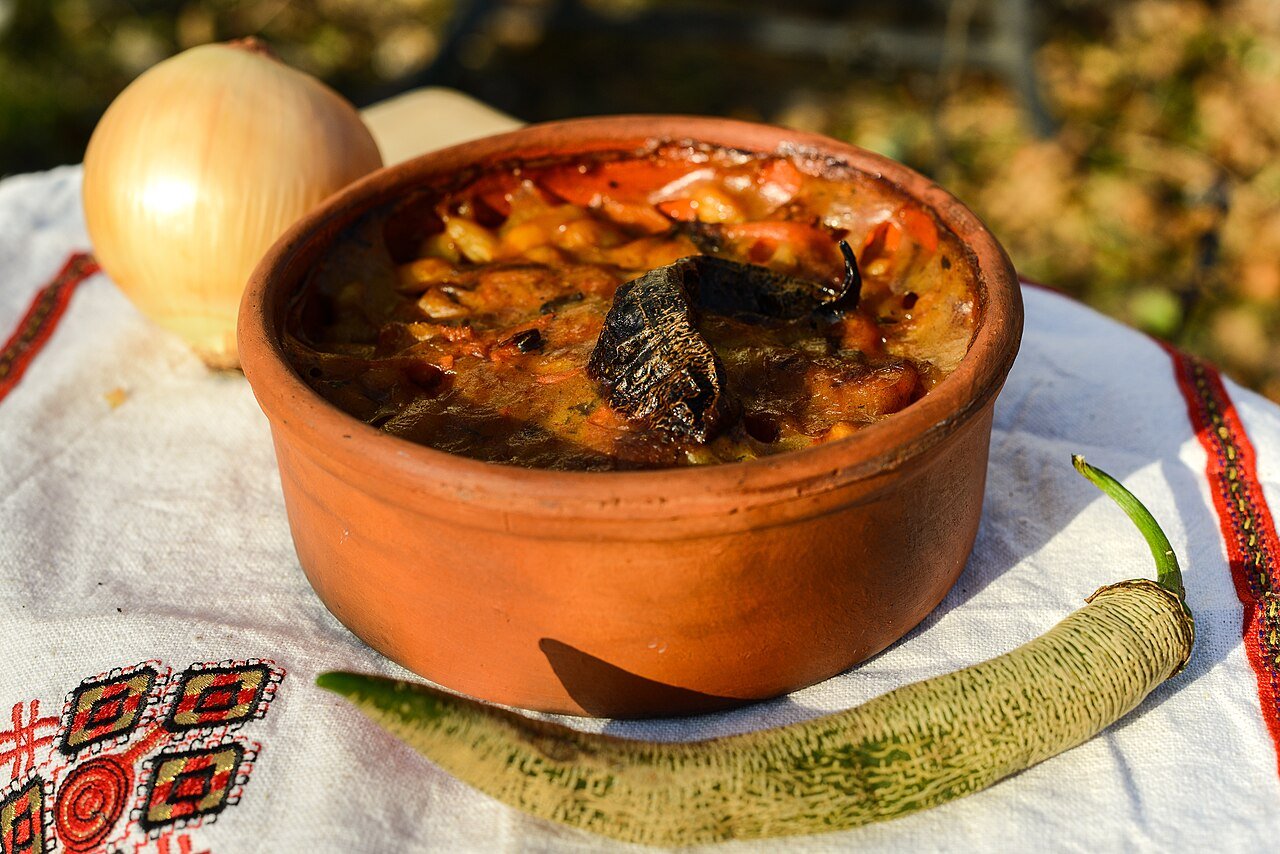 Tavče gravče — North Macedonia's signature baked-bean dish — served traditionally in an earthenware pot