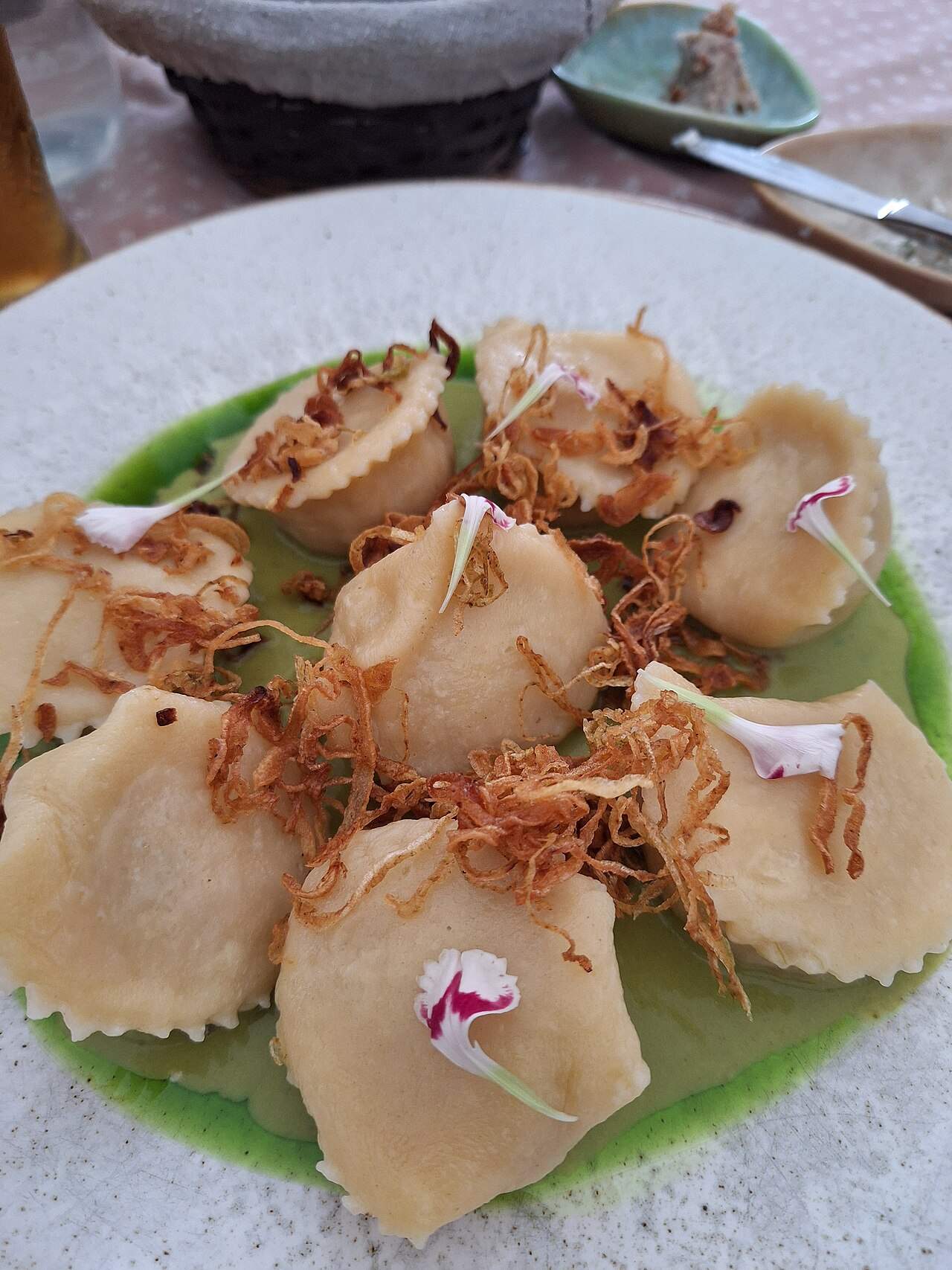 Polish pierogi dumplings topped with crispy fried onions, served in Katowice, Poland