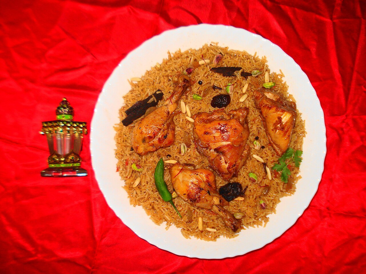 A platter of machboos — the spiced Gulf rice-and-meat dish popular in Qatar — with chicken, nuts and dried fruit