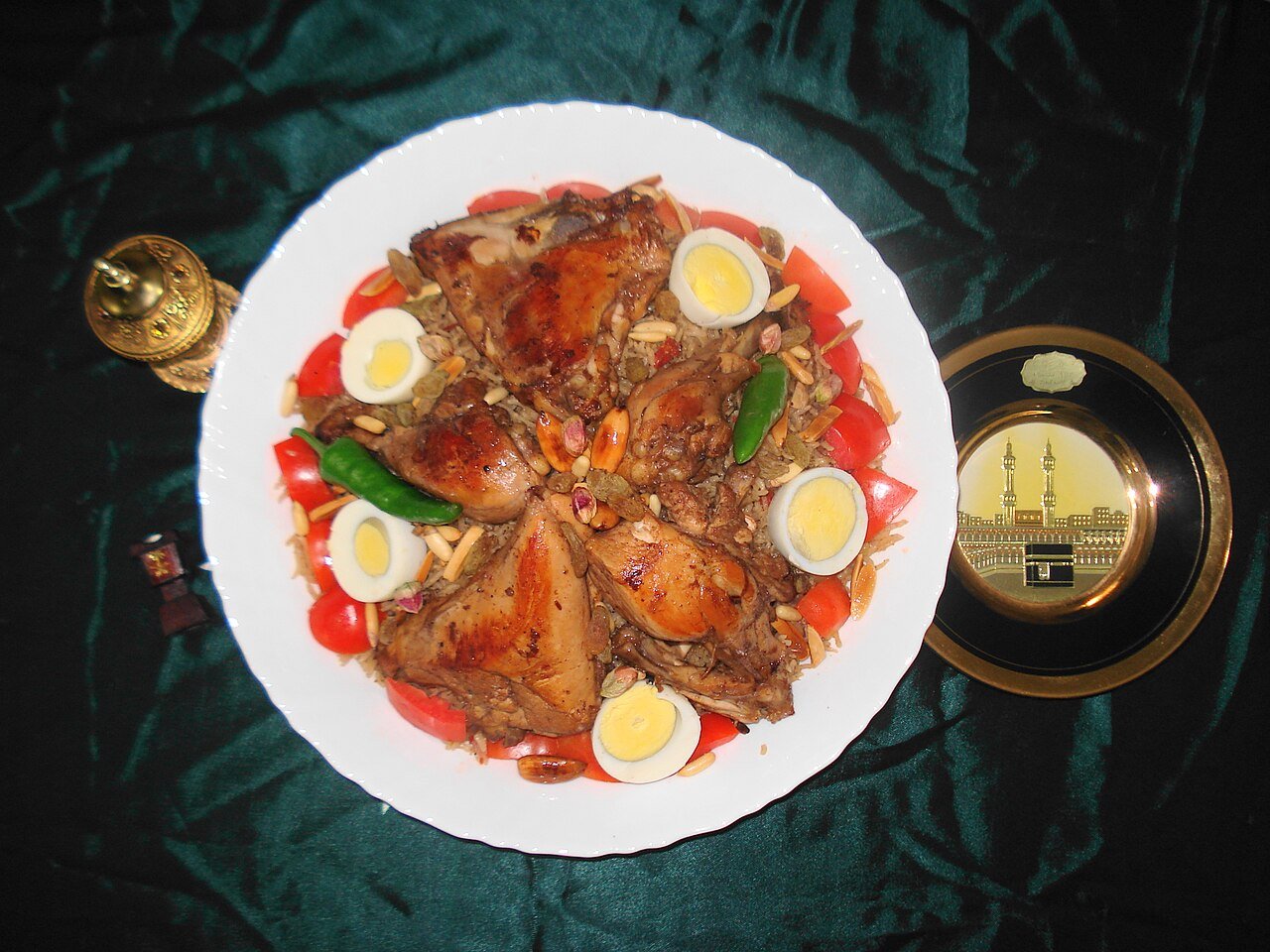 Kabsa — Saudi Arabia's national dish of spiced rice and chicken, garnished with eggs, tomatoes, nuts and raisins
