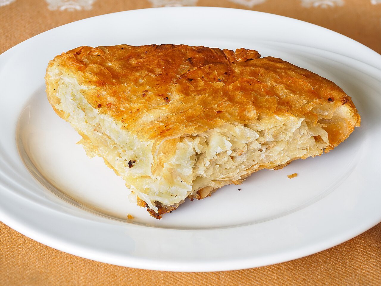 A slice of Serbian meat burek — flaky phyllo pastry filled with minced meat — from a Belgrade bakery