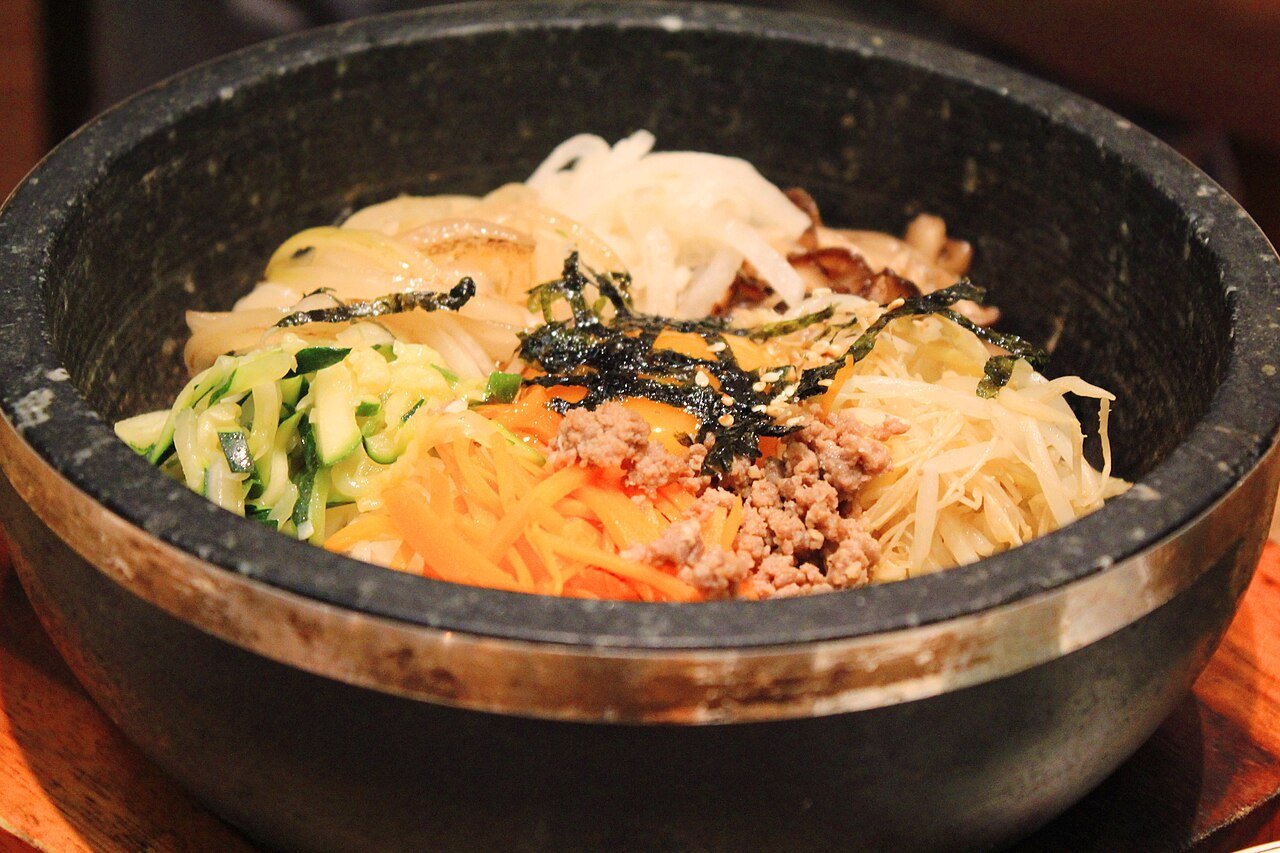 Dolsot bibimbap — sizzling stone bowl of rice, seasoned vegetables, beef and egg — in Seoul, South Korea