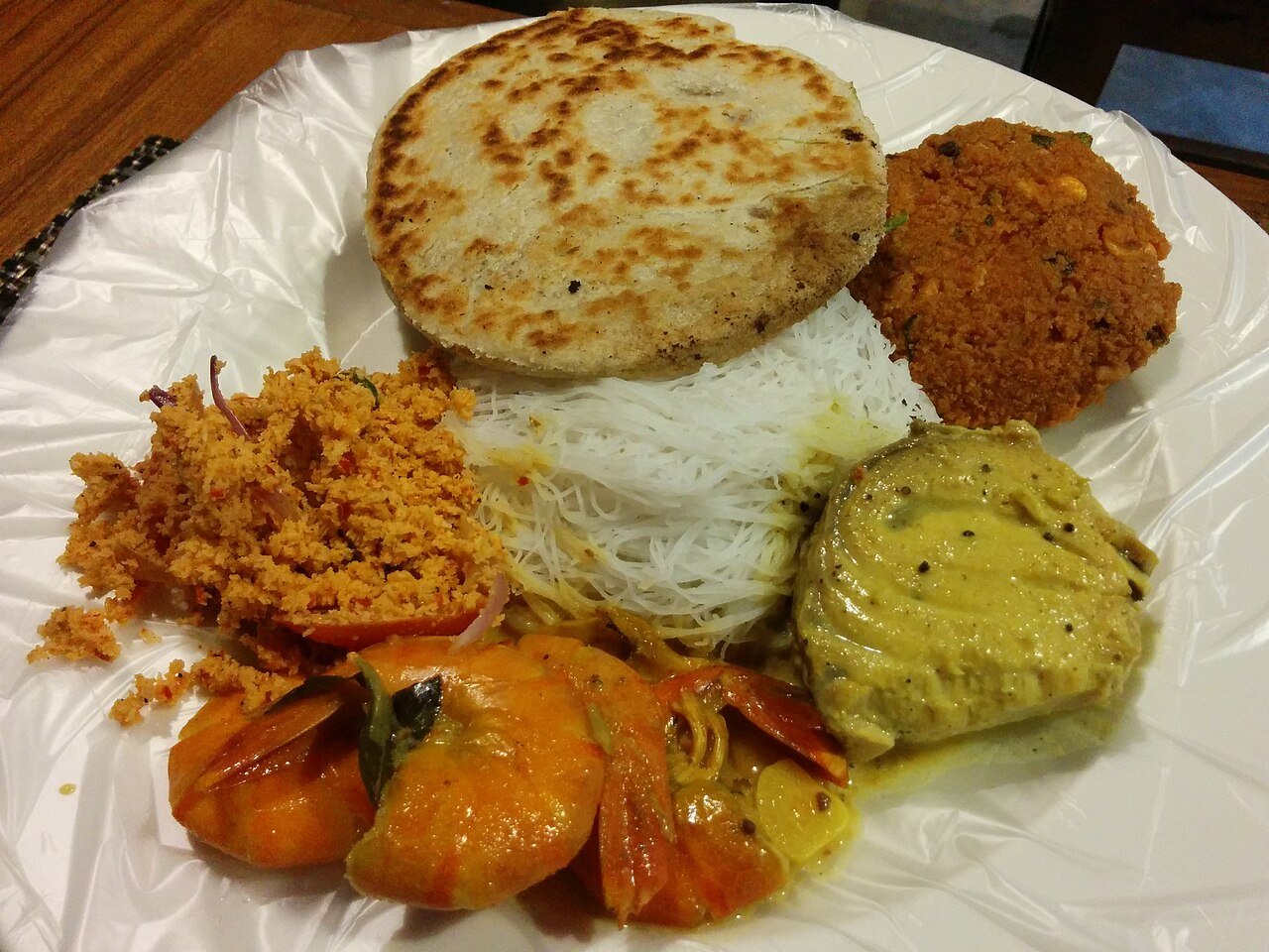 A Sri Lankan breakfast in Colombo of string hoppers with coconut sambol, roti, prawn curry and fish