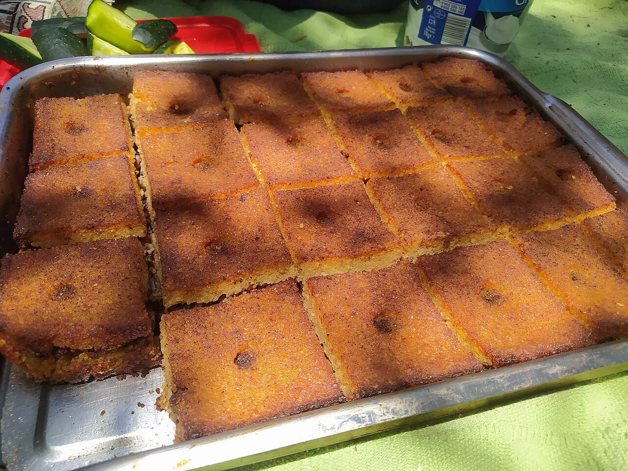 A tray of kibbeh bi'l-siniyeh, baked bulgur and minced meat cut into squares