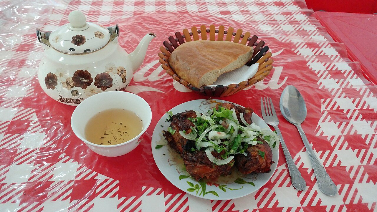 A meal at a bazaar in Ashgabat — chicken with onion and herbs, bread and green tea