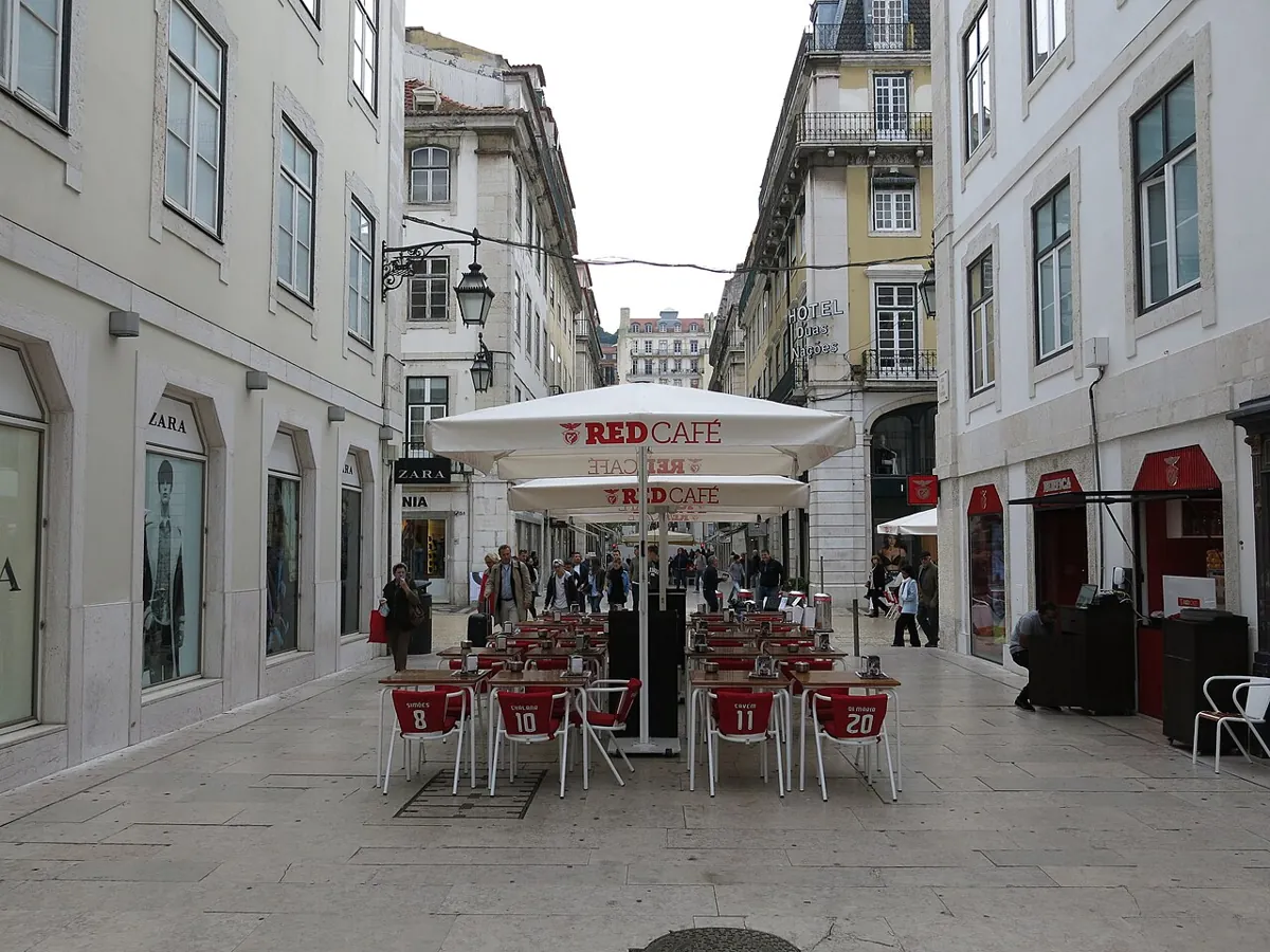 Outdoor tables at Red Cafe line Rua da Vitória in Lisbon.