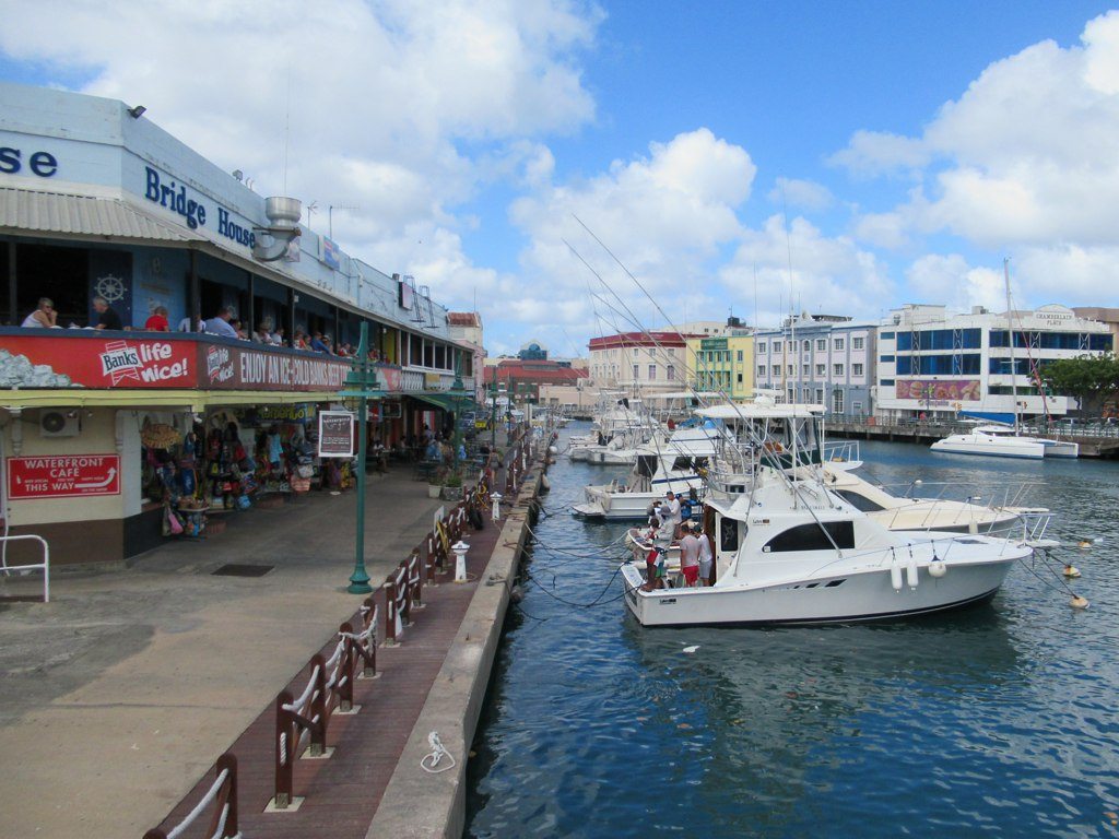 Boats moored in the Careenage beside colorful buildings in Bridgetown, Barbados