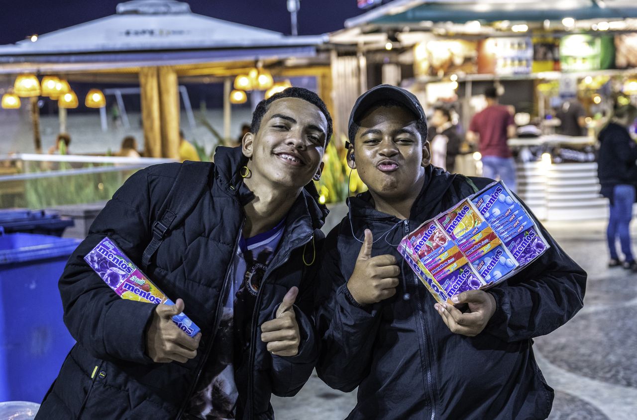 Two street vendors sell sweets on the Copacabana promenade at night, Rio de Janeiro, Brazil