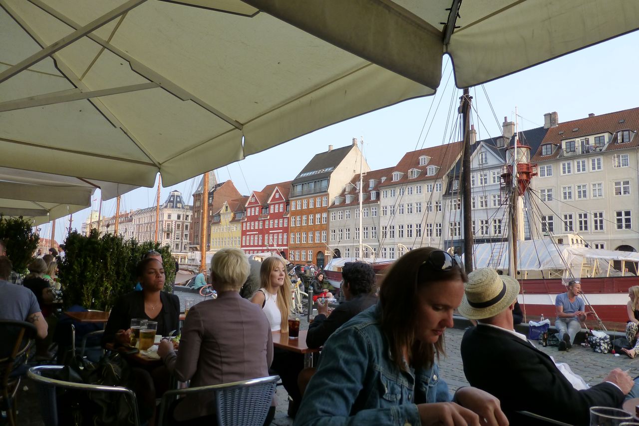 Cafés and colorful waterfront buildings along the Nyhavn canal in Copenhagen, Denmark