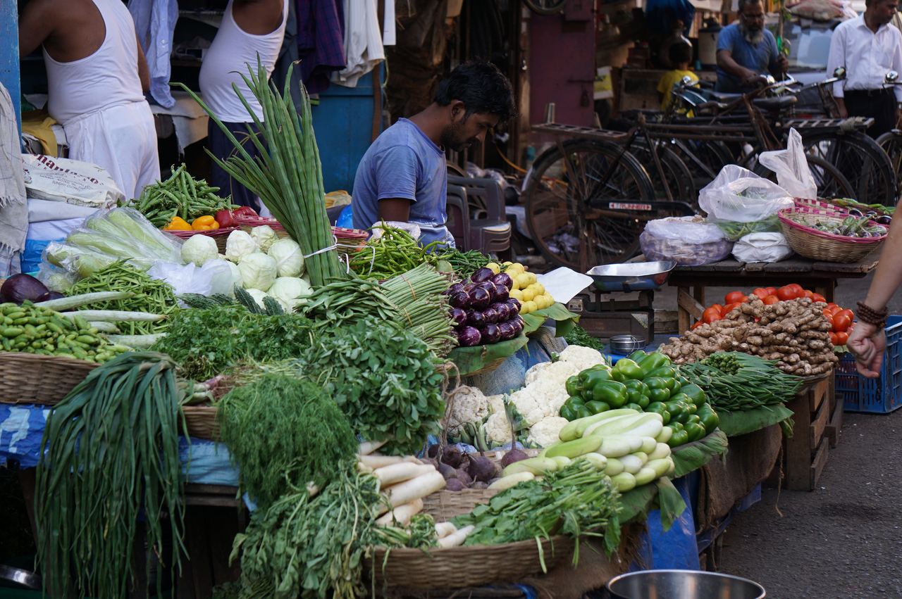 Vendors and shoppers at a vegetable street market in Mumbai, India