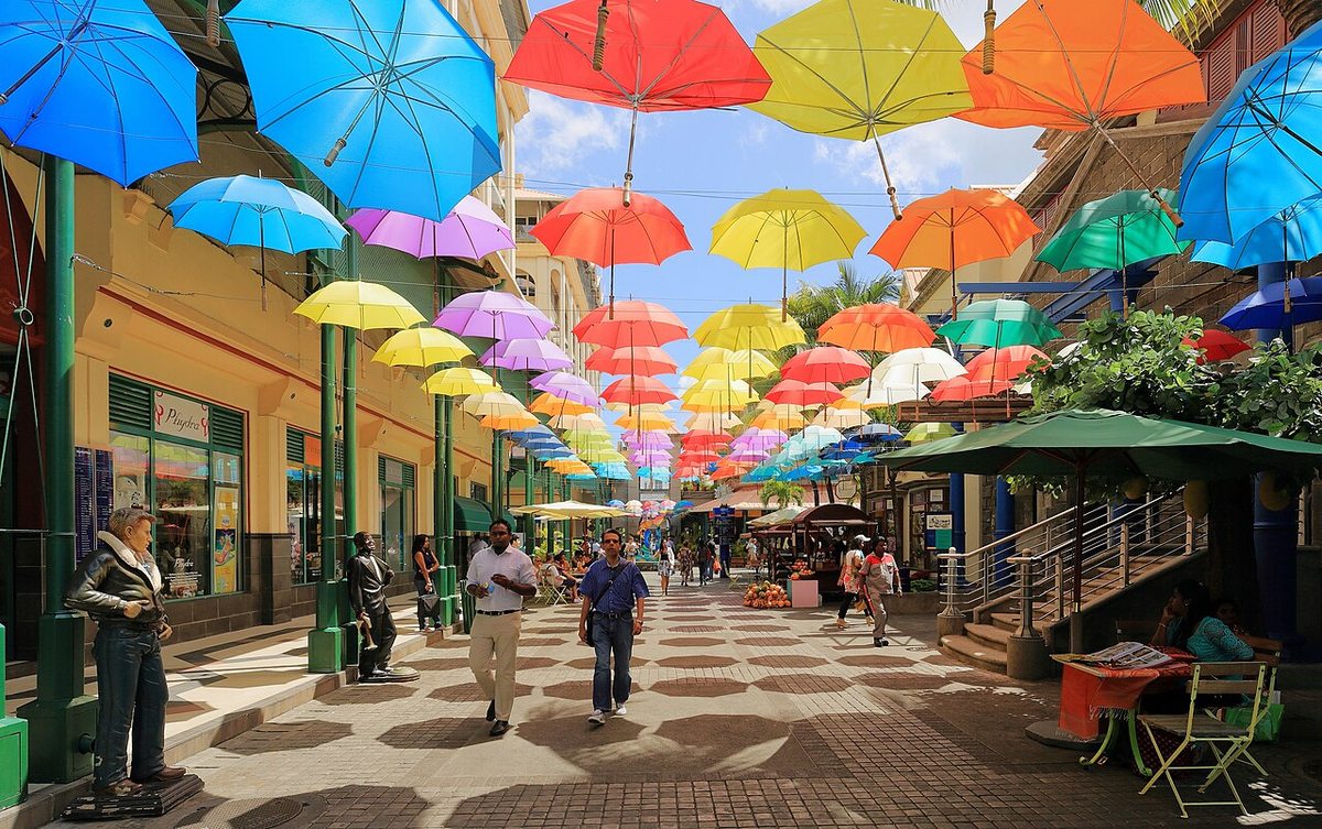 Colorful umbrellas suspended above a walkway at Caudan Waterfront in Port Louis, Mauritius