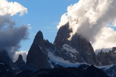 Clouds gather around the granite peaks of Mount Fitz Roy in Patagonia.