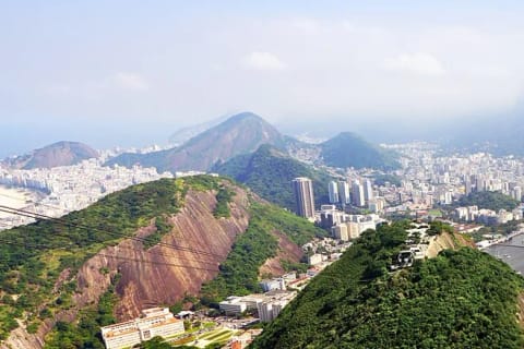Rio de Janeiro’s green hills, dense neighborhoods and bays seen from Sugarloaf Mountain.