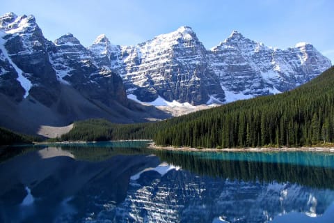 Moraine Lake reflects the snowy peaks of the Canadian Rockies.